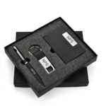 Black presentation box containing a matching matte black and silver pen, keyring, and business card holder set.