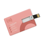 A flat, pink credit card-style USB flash drive with the connector folded out, featuring customisable placeholder text for a business logo and contact details.