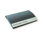 Black faux leather and metal business card holder featuring custom name engraving on the bottom metal strip.