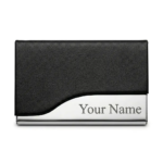 Black faux-leather and polished stainless steel business card holder featuring custom engraved text on the metal base.