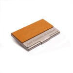 Wood and metal business card holder featuring custom engraved text on the metallic band.