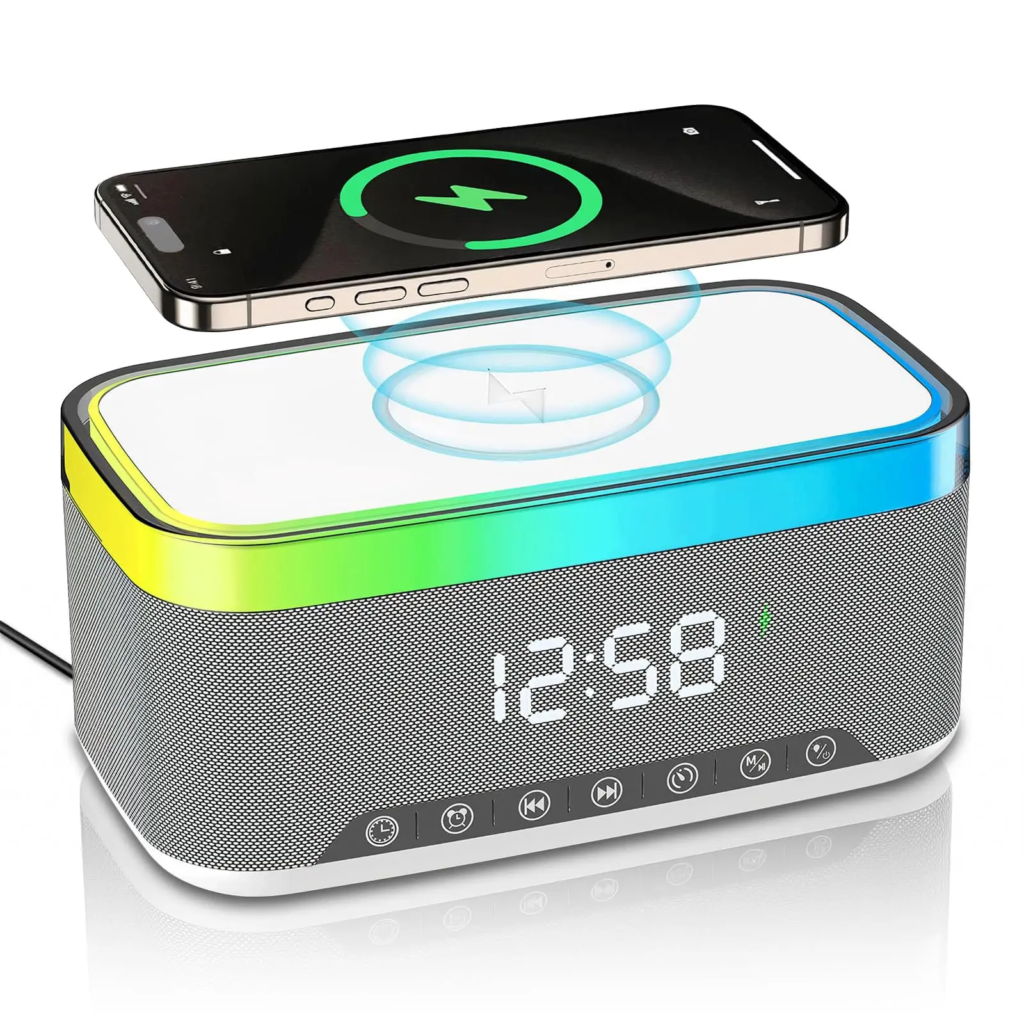 A multifunctional desk device featuring a top wireless charging pad with a smartphone on it, an integrated Bluetooth speaker, a digital clock display, and a color-changing ambient light ring.